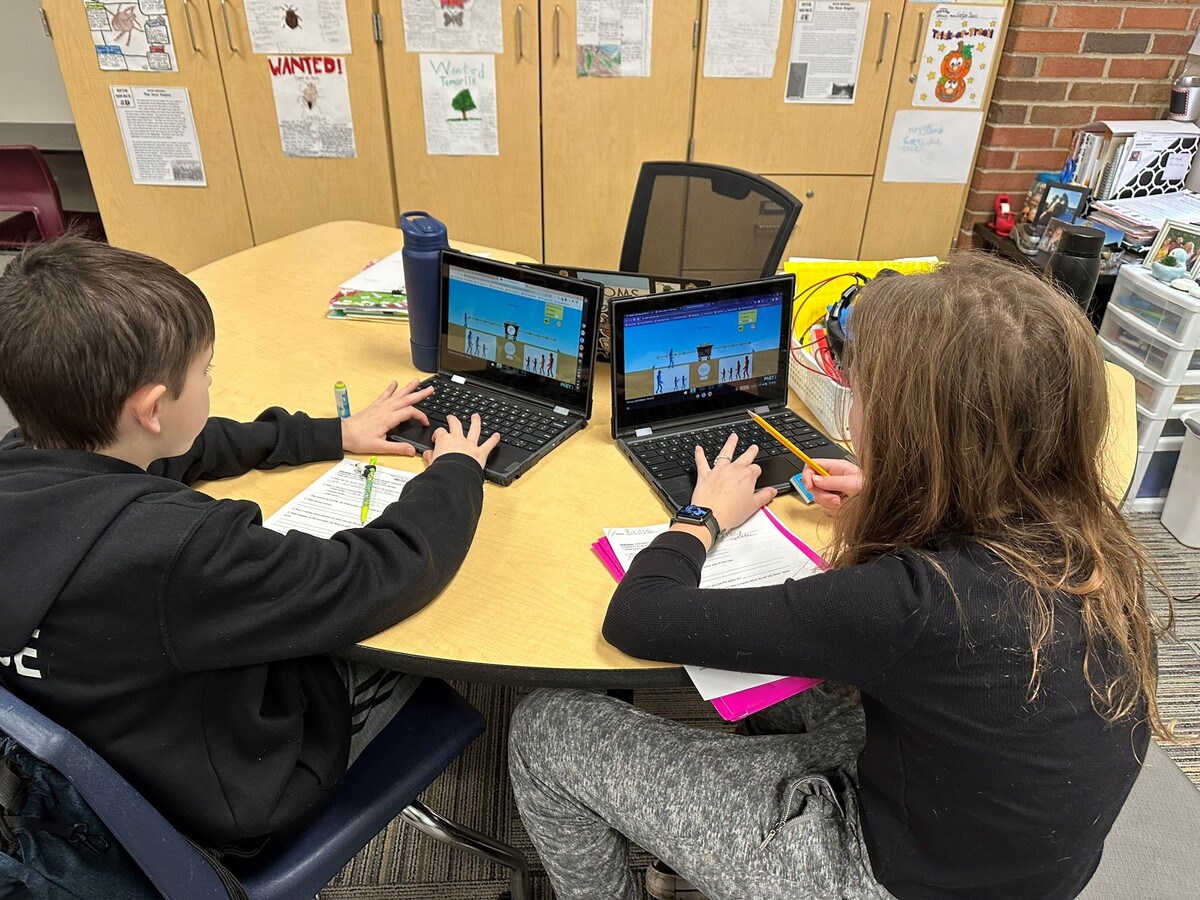 students work on laptops